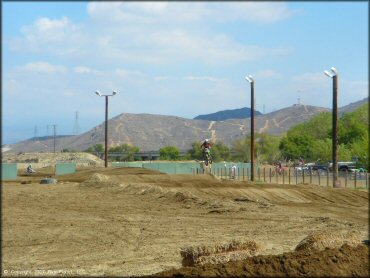 Kawasaki KX Motorcycle catching some air at Milestone Ranch MX Park Track