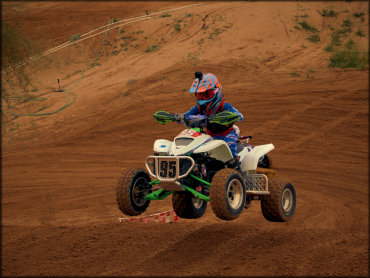 A Young ATV Rider Jumping a Tabletop Jump