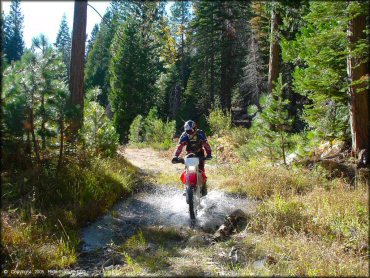 Honda CRF Motorcycle crossing some water at Indian Springs Trail