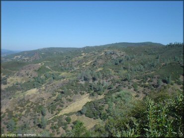 Scenic view of rolling hills and trees.