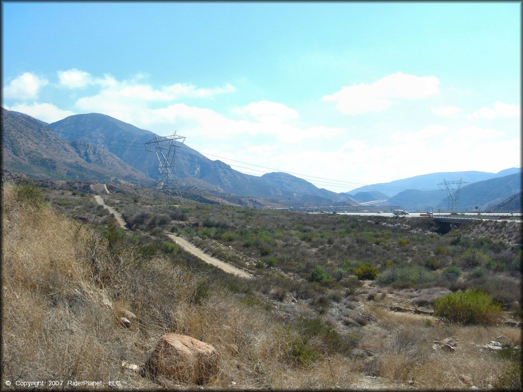 Scenic view of jeep trail with mountains in the background.