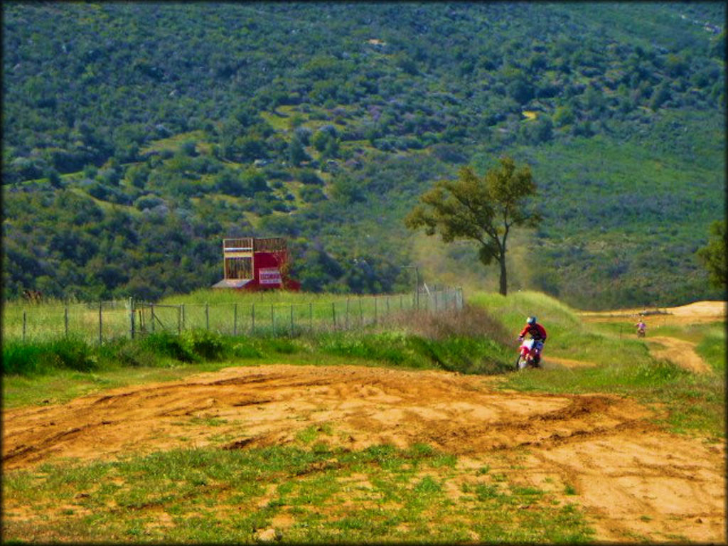 Two motocross racers on dirt track.