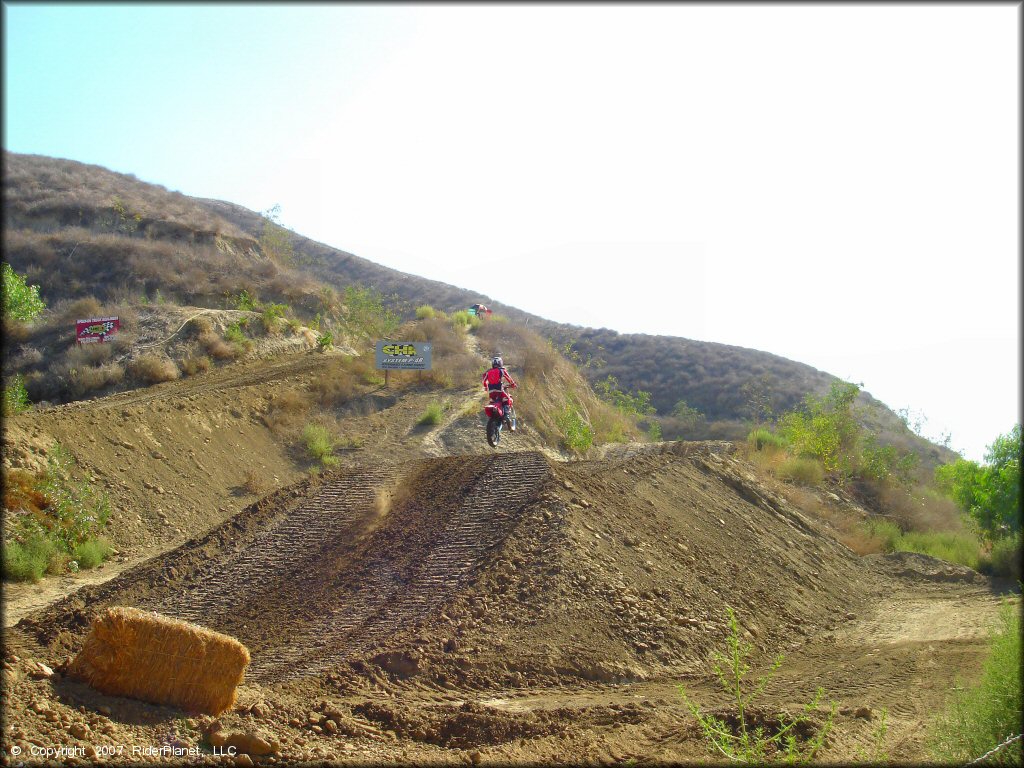 Honda CRF Dirt Bike catching some air at MX-126 Track